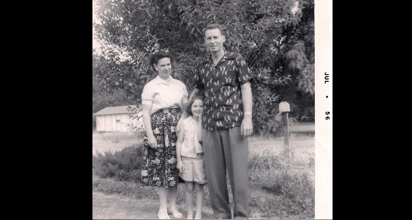 Laura and parents 1956